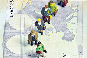 Figurines of people on a banknote